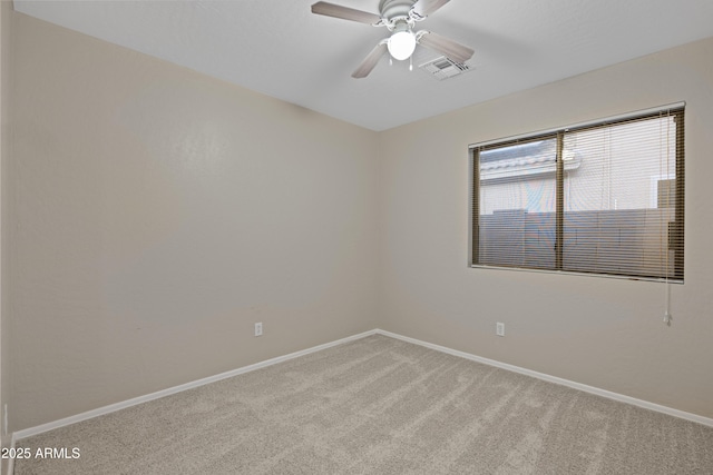 spare room with baseboards, visible vents, a ceiling fan, and carpet flooring