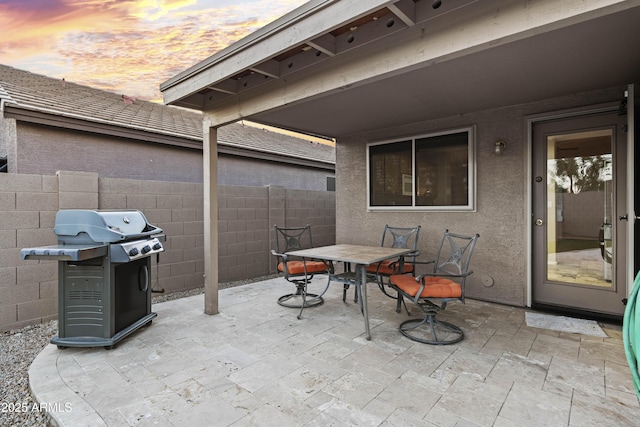 view of patio / terrace with area for grilling, outdoor dining space, and fence