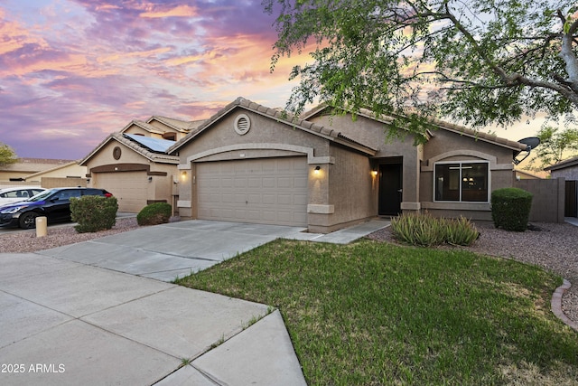 single story home featuring stucco siding, fence, a front yard, concrete driveway, and an attached garage