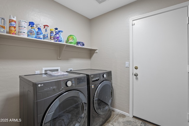 laundry room featuring washer and dryer, visible vents, laundry area, and baseboards