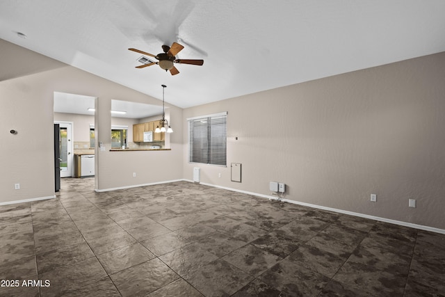unfurnished living room with a ceiling fan, vaulted ceiling, and baseboards