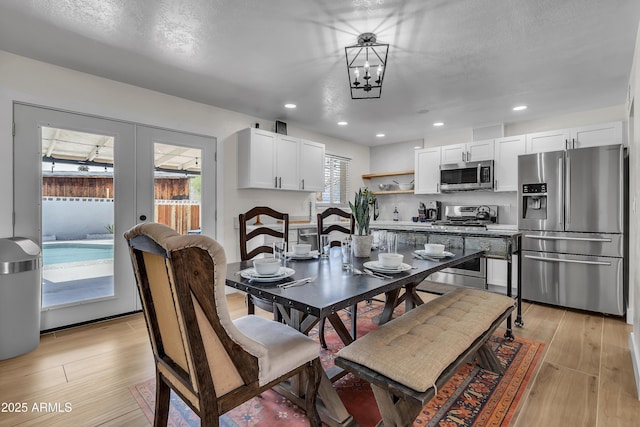1209 E Marigold Ln, Tempe, AZ 85288 - dining room with light wood finished floors, french doors, recessed lighting, and a chandelier
