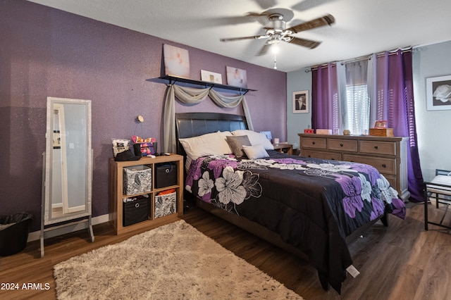 bedroom with ceiling fan and dark hardwood / wood-style flooring