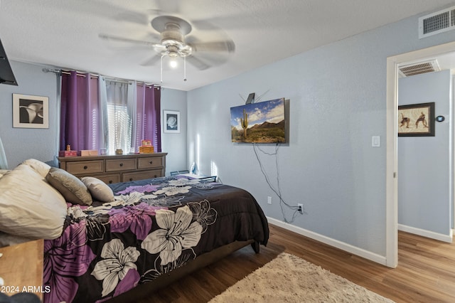 bedroom featuring hardwood / wood-style floors and ceiling fan