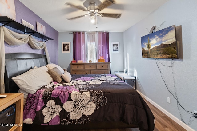 bedroom with ceiling fan and wood-type flooring