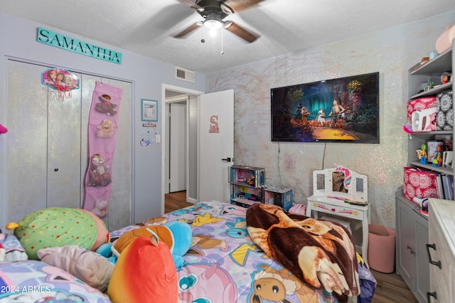 bedroom featuring ceiling fan, a closet, and light wood-type flooring