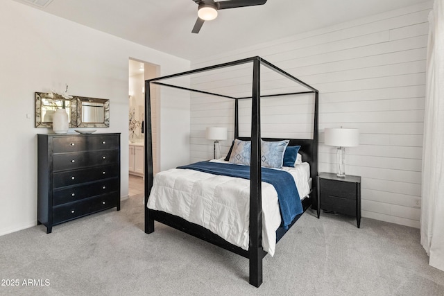 bedroom featuring carpet, a ceiling fan, and ensuite bath