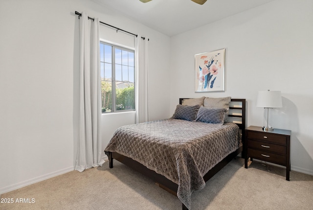 bedroom featuring baseboards, light carpet, and a ceiling fan