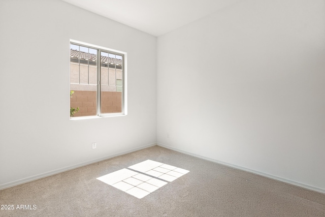 spare room with carpet flooring and baseboards