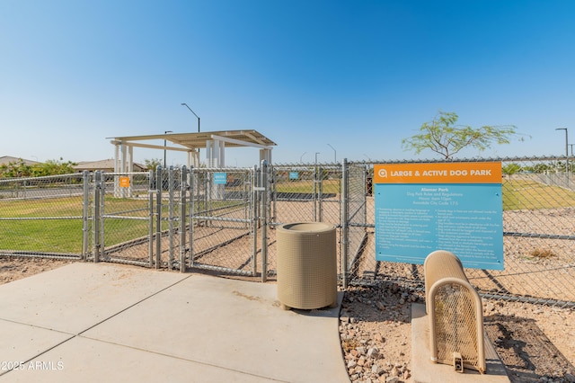 exterior space featuring central air condition unit, fence, and a gate