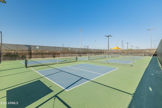 view of tennis court with fence