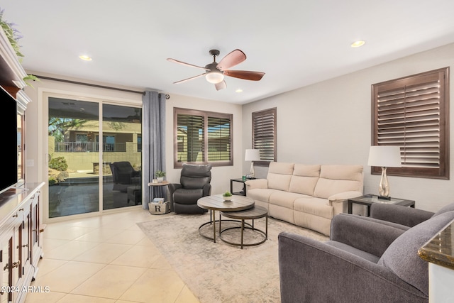 living room featuring light tile patterned flooring, plenty of natural light, and ceiling fan