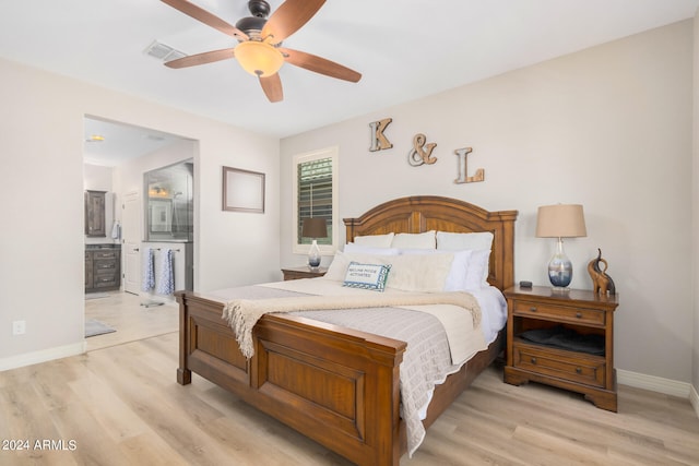 bedroom featuring connected bathroom, light wood-type flooring, and ceiling fan