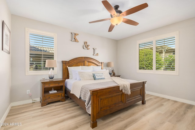 bedroom with light hardwood / wood-style floors and ceiling fan