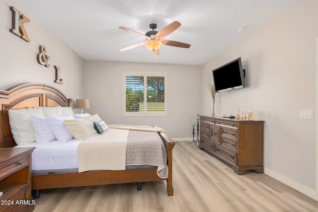 bedroom with light hardwood / wood-style floors and ceiling fan