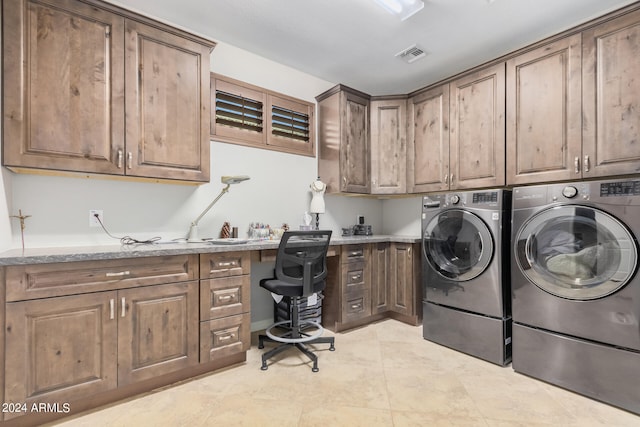 laundry area featuring washer and dryer and cabinets