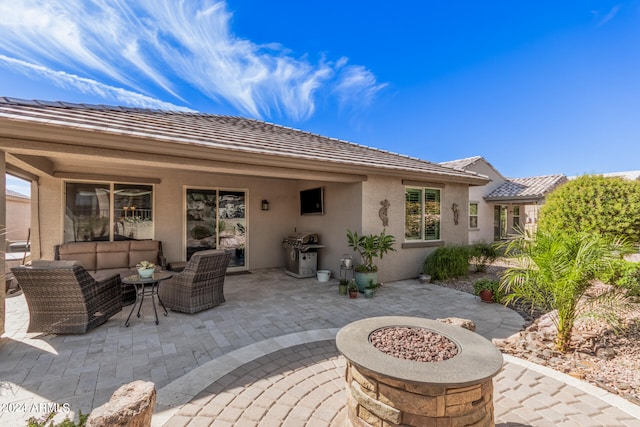 view of patio / terrace featuring an outdoor living space with a fire pit