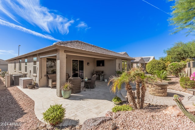 rear view of property with central air condition unit, a patio area, and outdoor lounge area