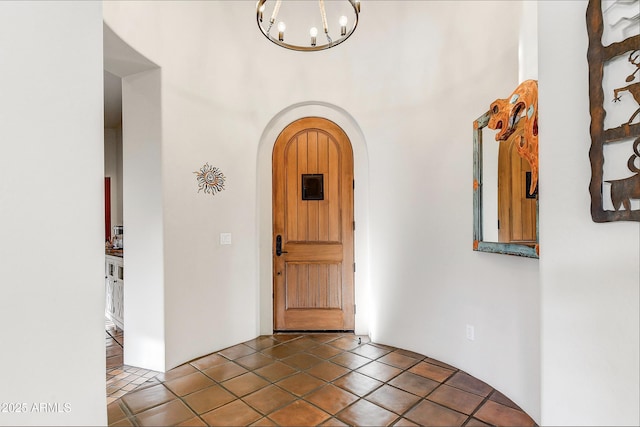 entrance foyer with tile patterned floors and a notable chandelier