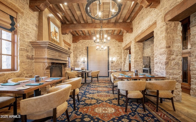 dining room featuring beam ceiling, a chandelier, and wooden ceiling