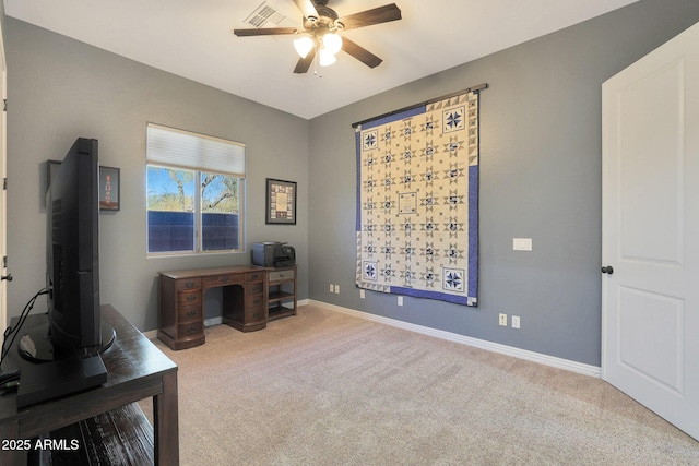 carpeted office featuring ceiling fan