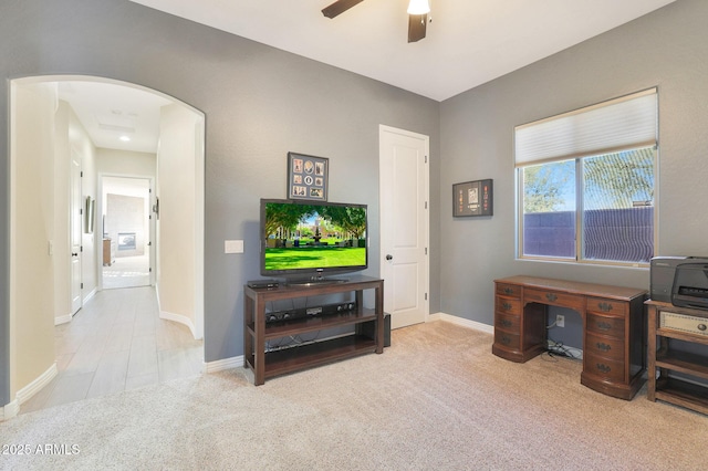 office space with light colored carpet and ceiling fan