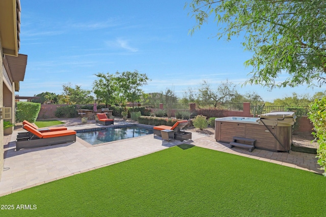 view of swimming pool with a patio area and a hot tub