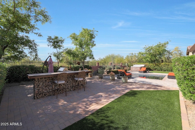 view of patio with a grill, a swimming pool with hot tub, and a bar