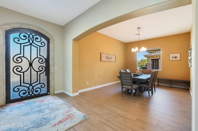 foyer featuring light hardwood / wood-style floors and an inviting chandelier