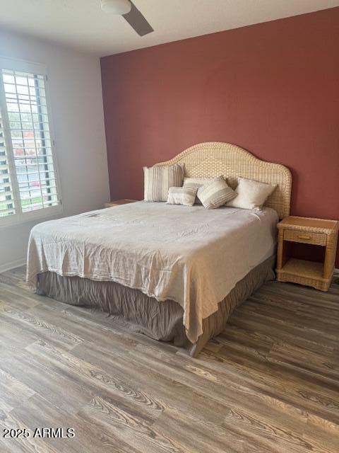 bedroom with hardwood / wood-style floors and ceiling fan