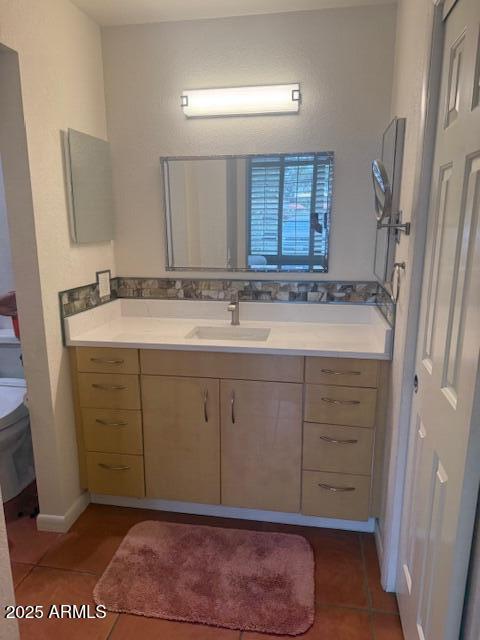 bathroom with vanity, tile patterned floors, and toilet