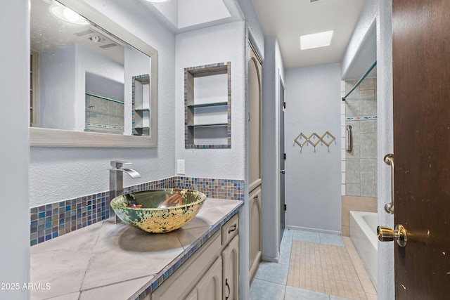 bathroom with tasteful backsplash, vanity, shower / bathtub combination, and tile patterned floors