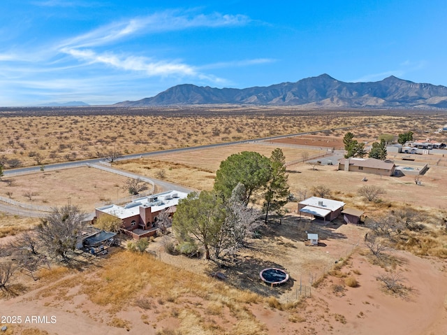 birds eye view of property with a rural view, a mountain view, and view of desert