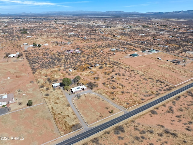 aerial view featuring a mountain view and a desert view