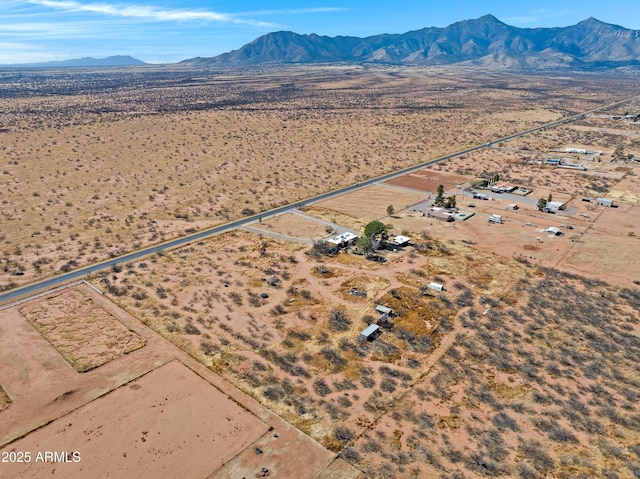 birds eye view of property featuring view of desert and a mountain view