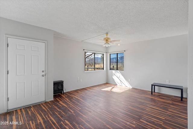 spare room featuring ceiling fan, a textured ceiling, and wood finished floors