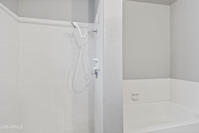 full bath featuring tiled shower and a garden tub