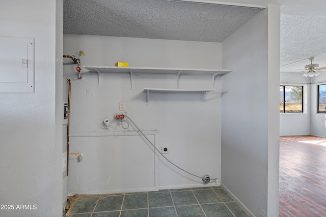 washroom featuring a textured ceiling, hookup for an electric dryer, laundry area, a ceiling fan, and electric panel