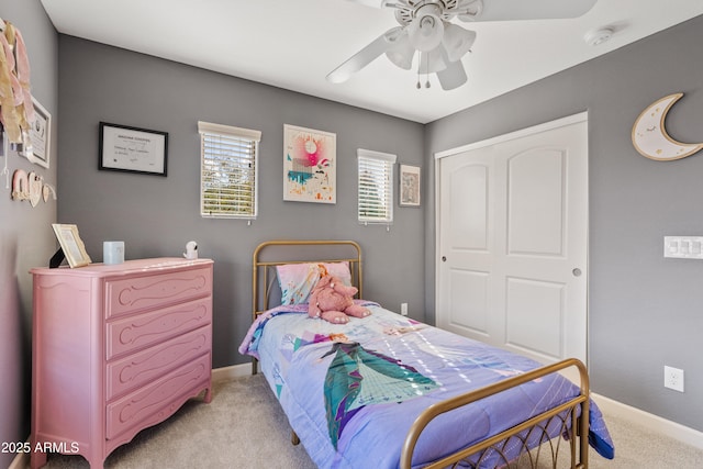 bedroom with light colored carpet, a closet, and ceiling fan