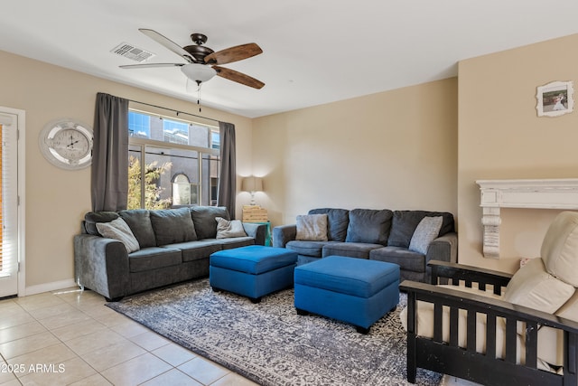 tiled living room with ceiling fan