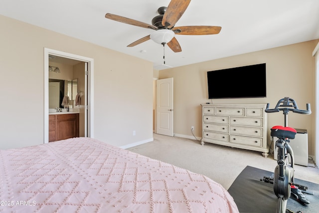 unfurnished bedroom featuring light carpet, connected bathroom, sink, and ceiling fan