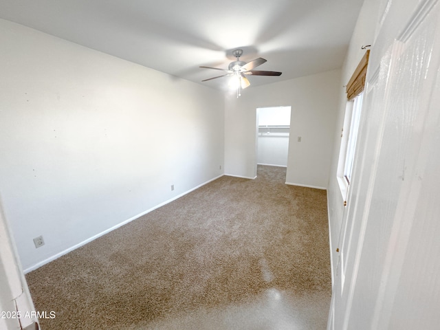 spare room with ceiling fan and carpet flooring