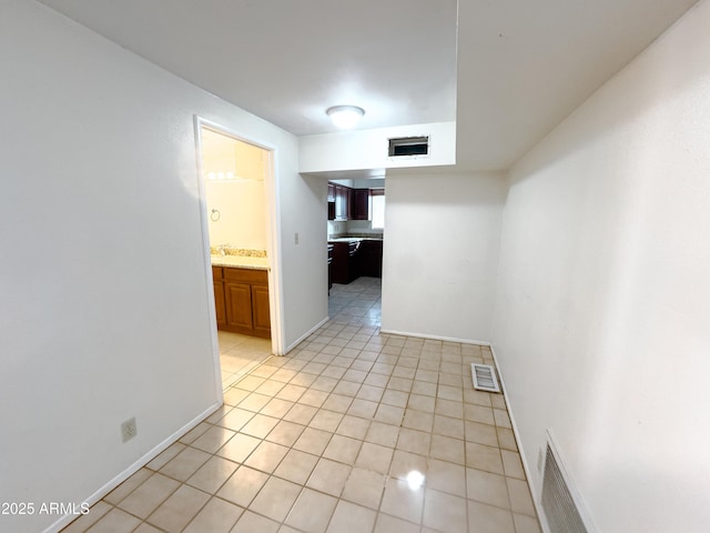 hallway featuring light tile patterned floors