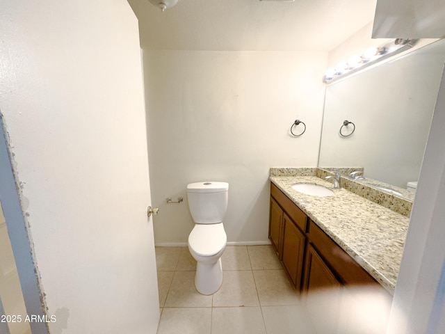 bathroom featuring tile patterned floors, vanity, and toilet