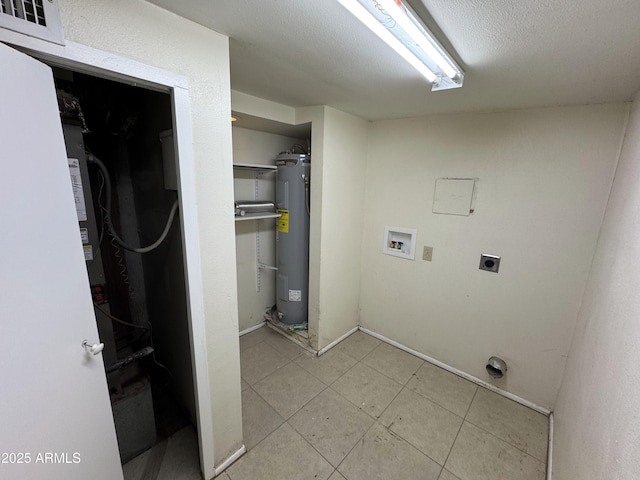 washroom featuring water heater, washer hookup, a textured ceiling, and electric dryer hookup