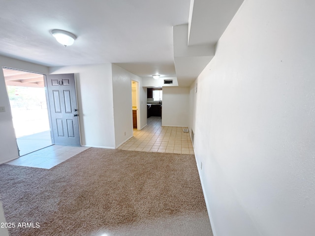 hallway with light colored carpet