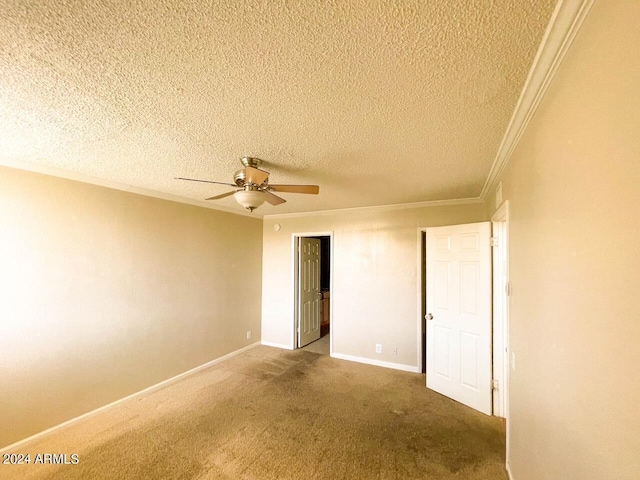 empty room with carpet flooring, a textured ceiling, ornamental molding, and ceiling fan