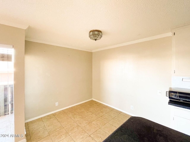 unfurnished room featuring a textured ceiling, light tile patterned floors, and ornamental molding