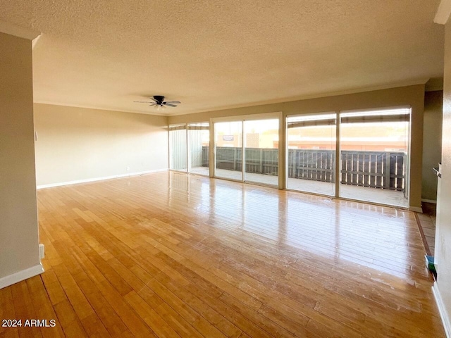 unfurnished room featuring light hardwood / wood-style flooring, a textured ceiling, and ceiling fan