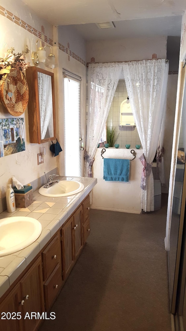 bathroom featuring double vanity and a sink